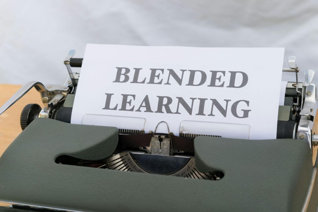Close-up of a vintage typewriter typing 'Blended Learning', symbolizing the integration of traditional and digital education.